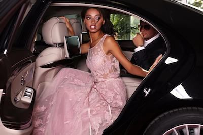 Elegantly dressed woman in luxury limousine